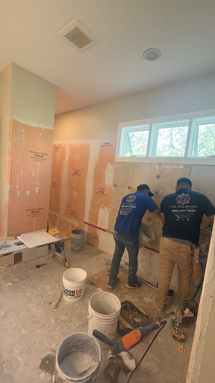 CJJ crew installing wall tile during a bathroom project